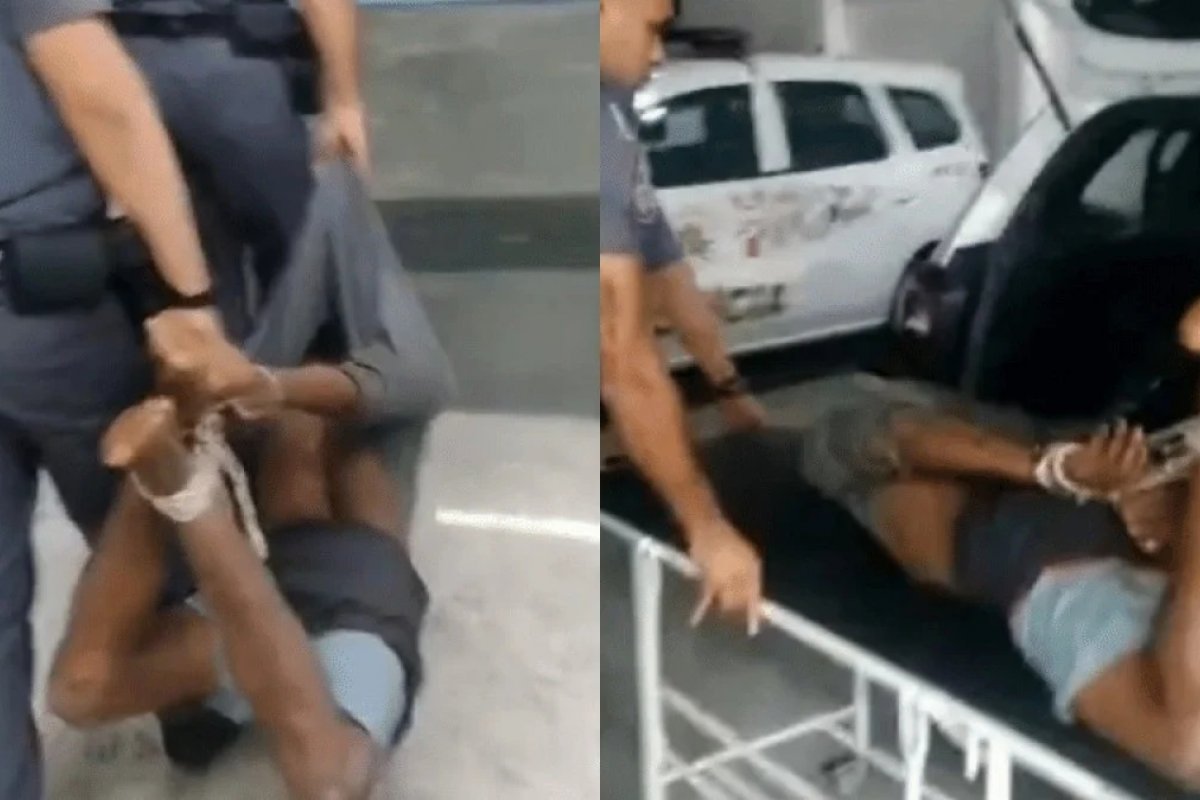 Homem negro é carregado com pés e mãos amarrados por PMs após prisão em SP