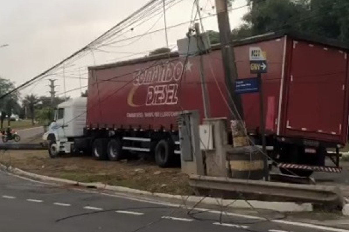 Vídeo: caminhão atinge poste, que cai em carro, na Avenida Paralela; duas pessoas ficam feridas 