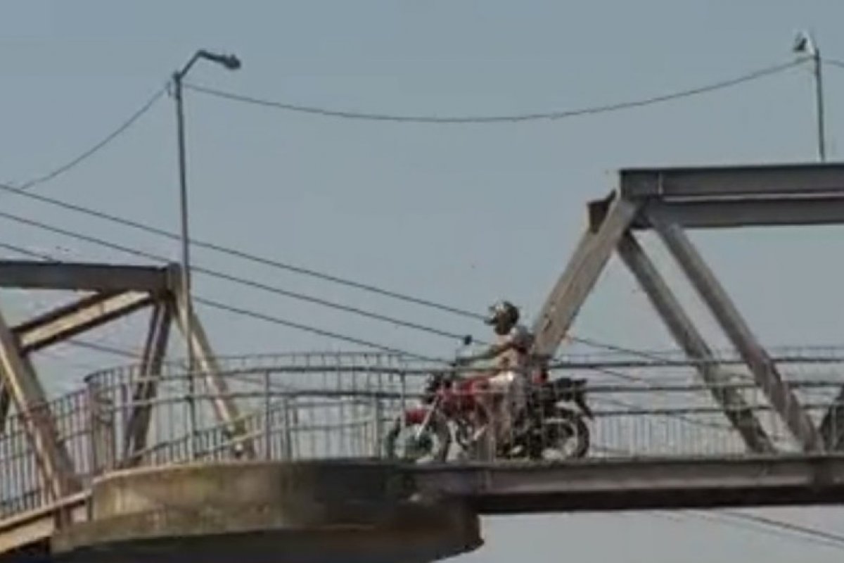 [PRF flagra homem atravessando passarela de rodovia com motocicleta em Salvador]